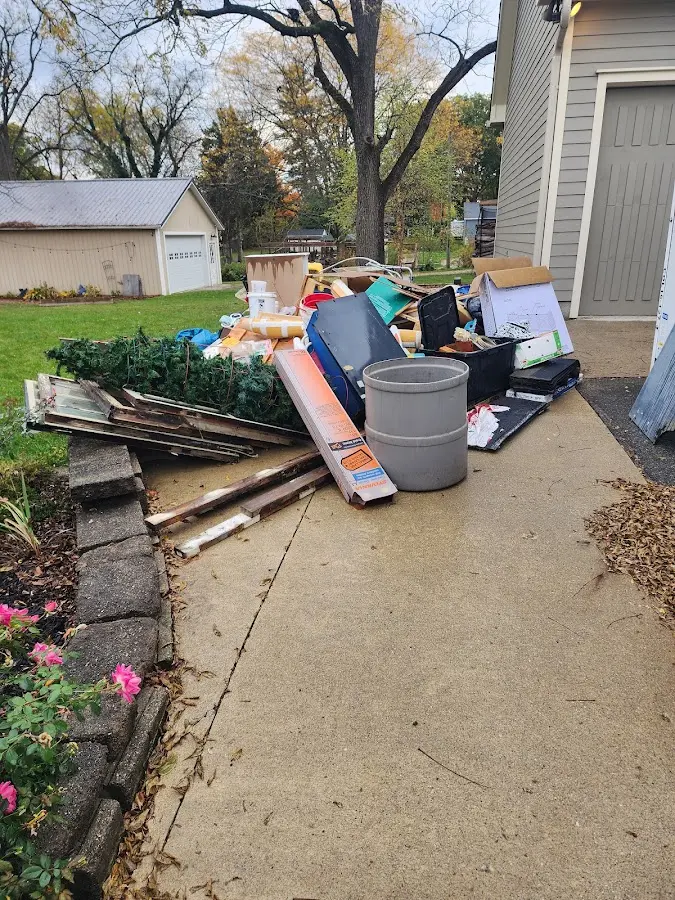 Dumpster being loaded with debris for Residential Dumpster Rental in Alma